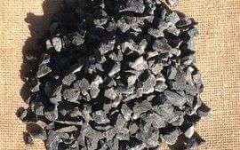 A small pile of black basalt, with a size of 10mm. Place on top of a hessian bag