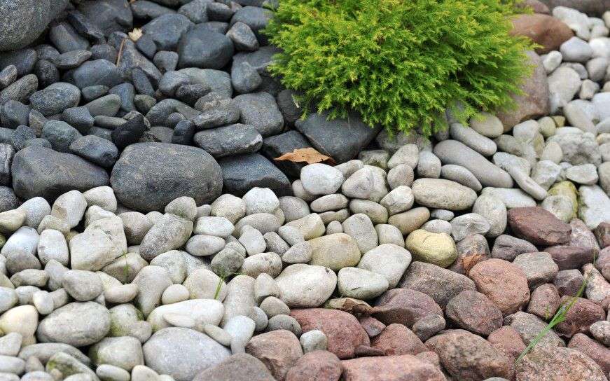 Creative landscaping ideas such as using different stones and pebbles as pictured